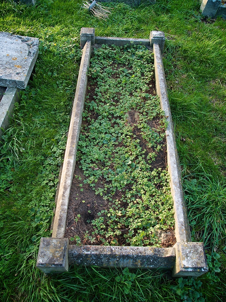 Old grave untended and overgrown.