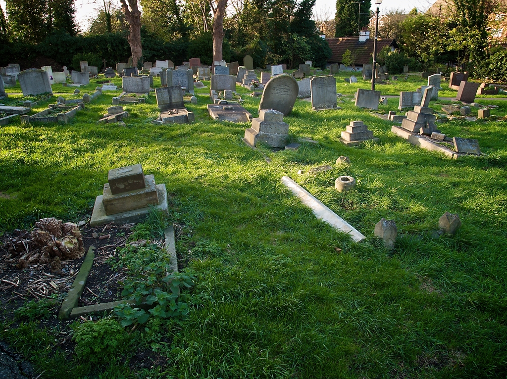 Old graves with broken headstones, untended and overgrown.